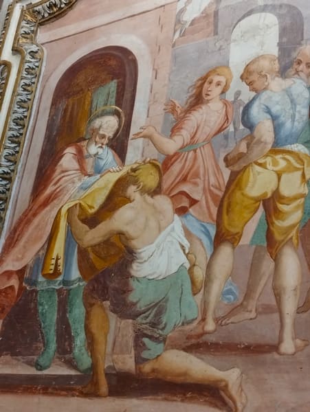 De heilige Omoboni schenkt zijn bezittingen aan de armen. Door Giuseppe Bastiani. San Benedetto kerk in Fabriano.
